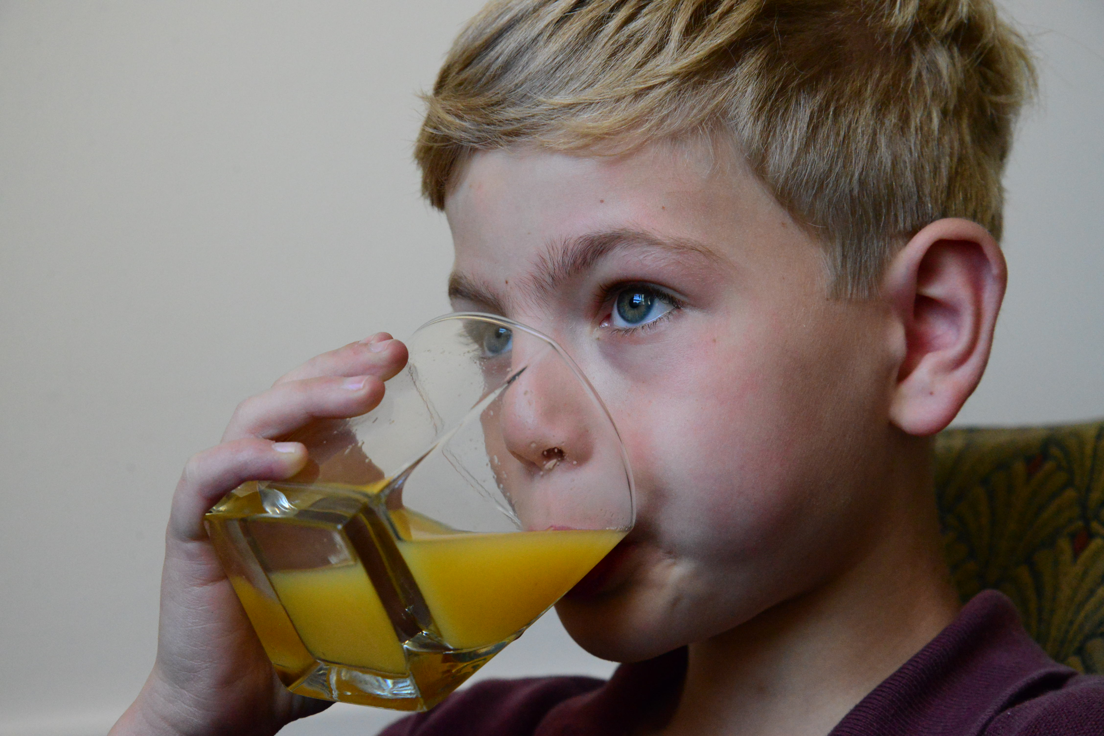child drinking OJ