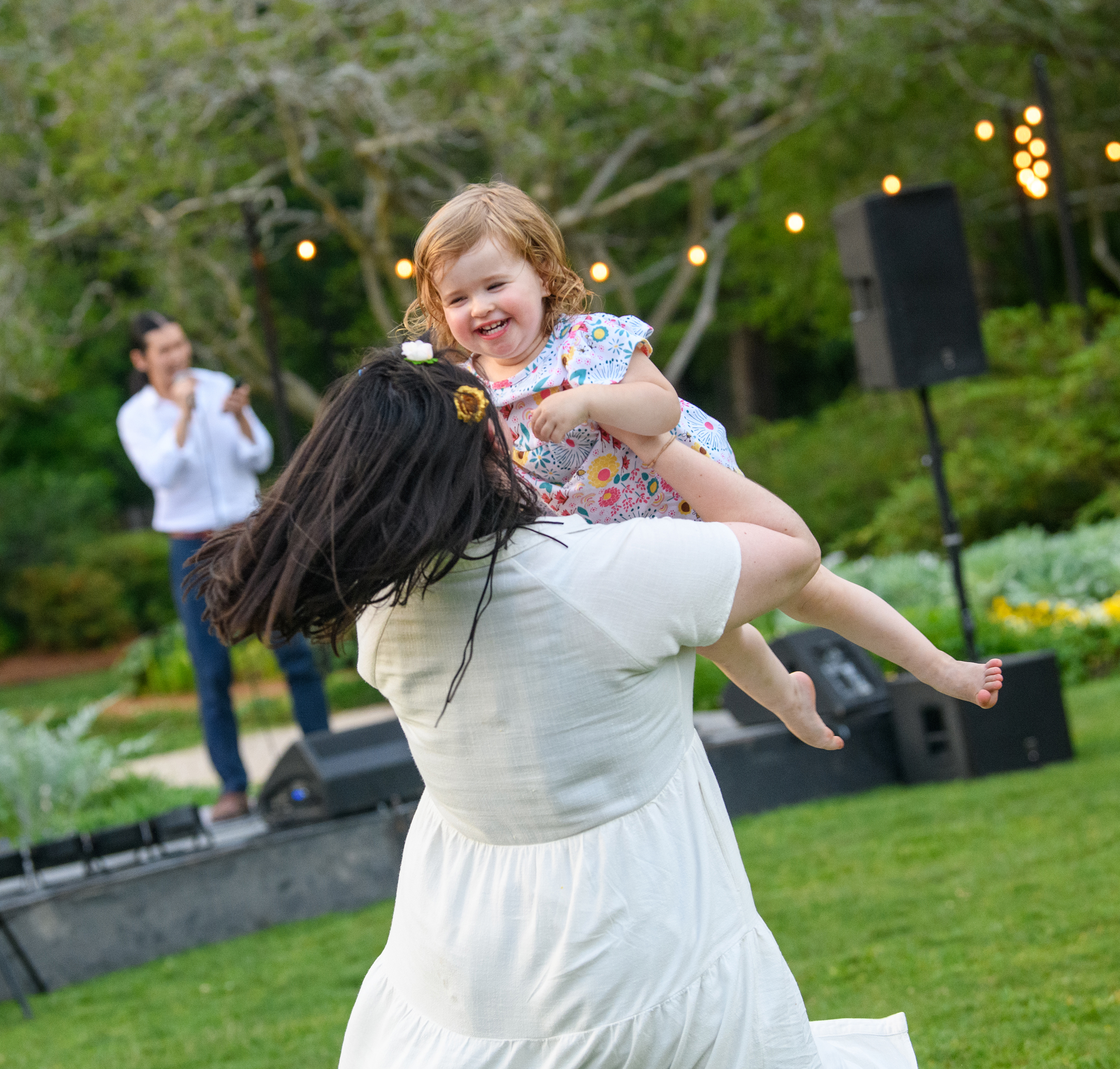 Woman with child dancing at the Music in the Gardens event.