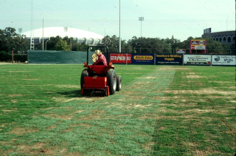 Image of slit seeder overseeding athletic turf.