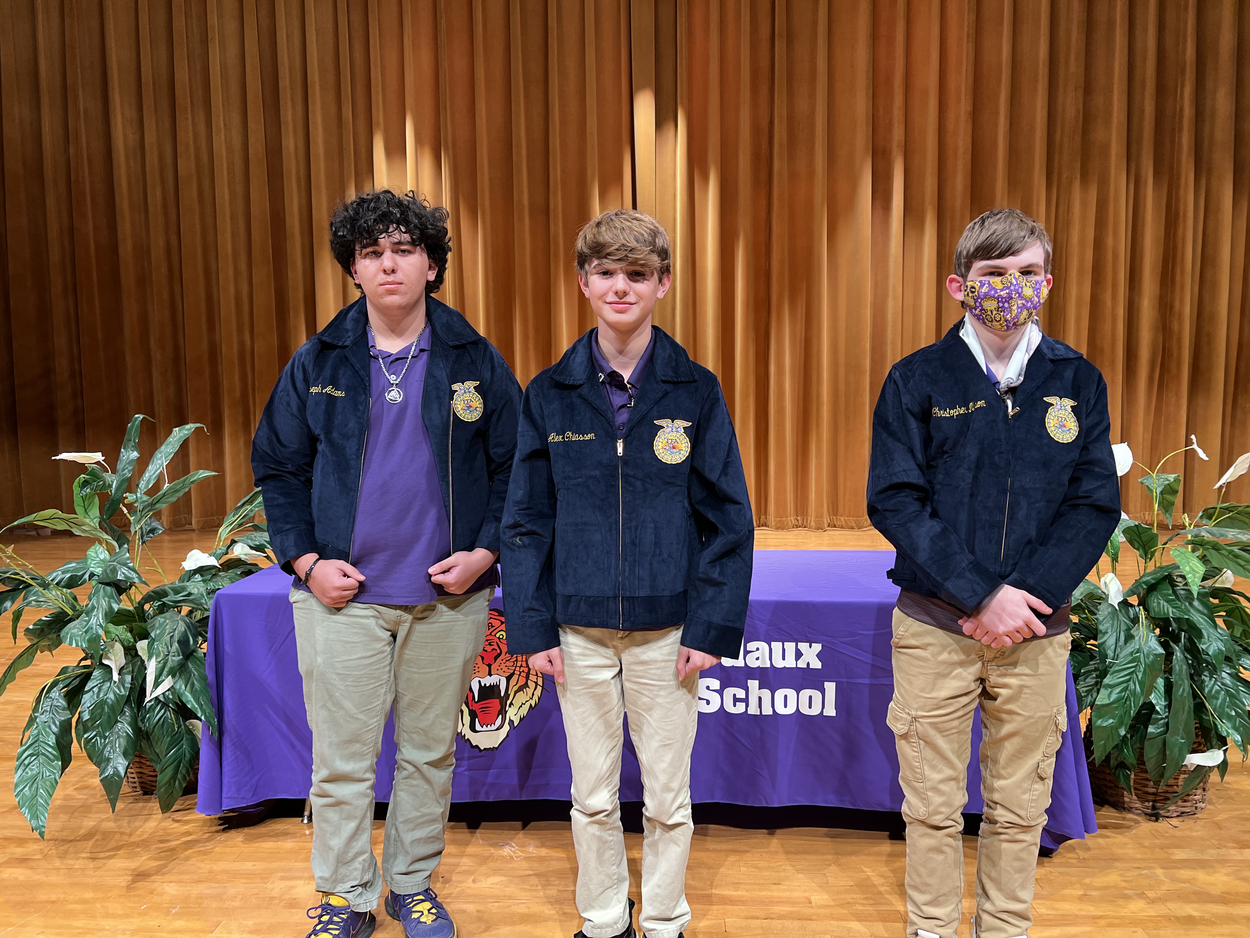Three youth that received new jackets.