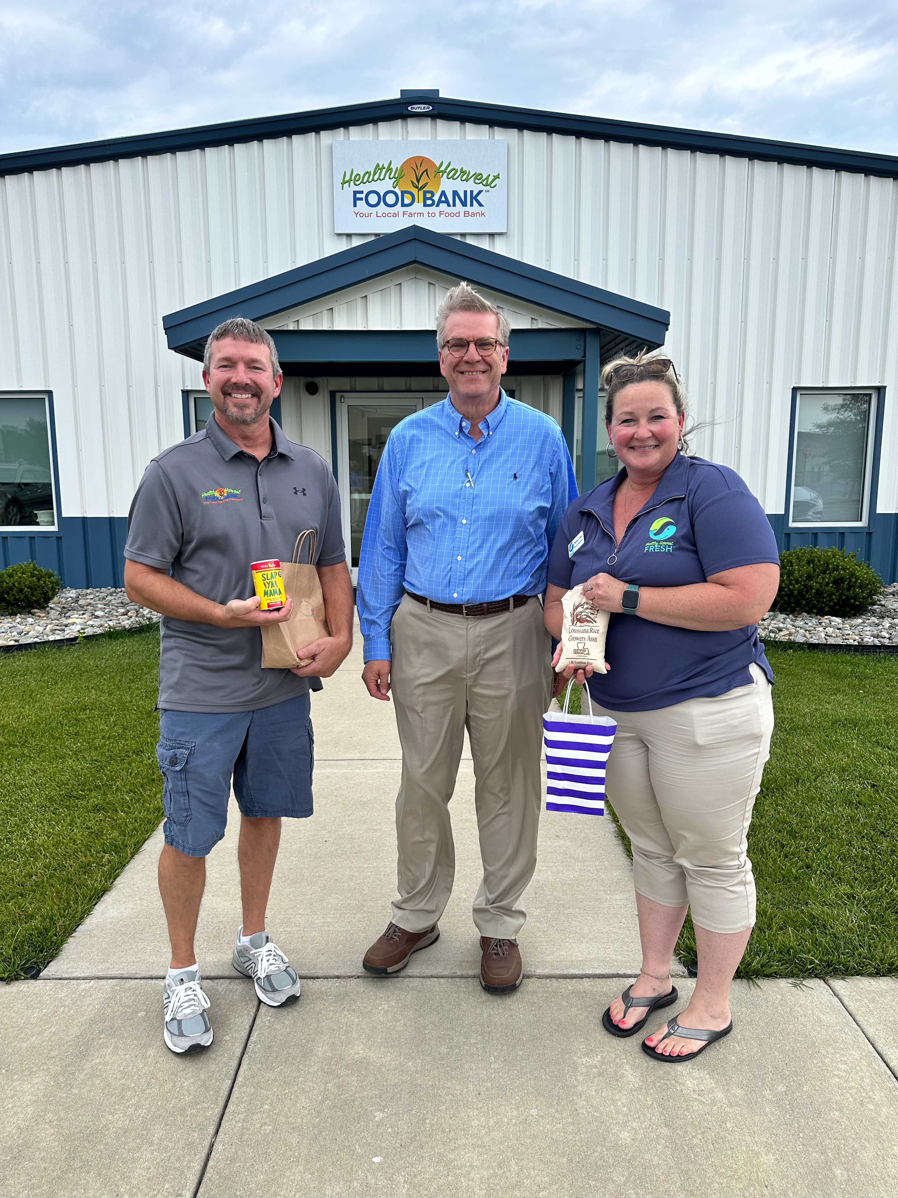 Dr. Soileau with employees of Healthy Harvest showing off the donations from Class XVIII. 