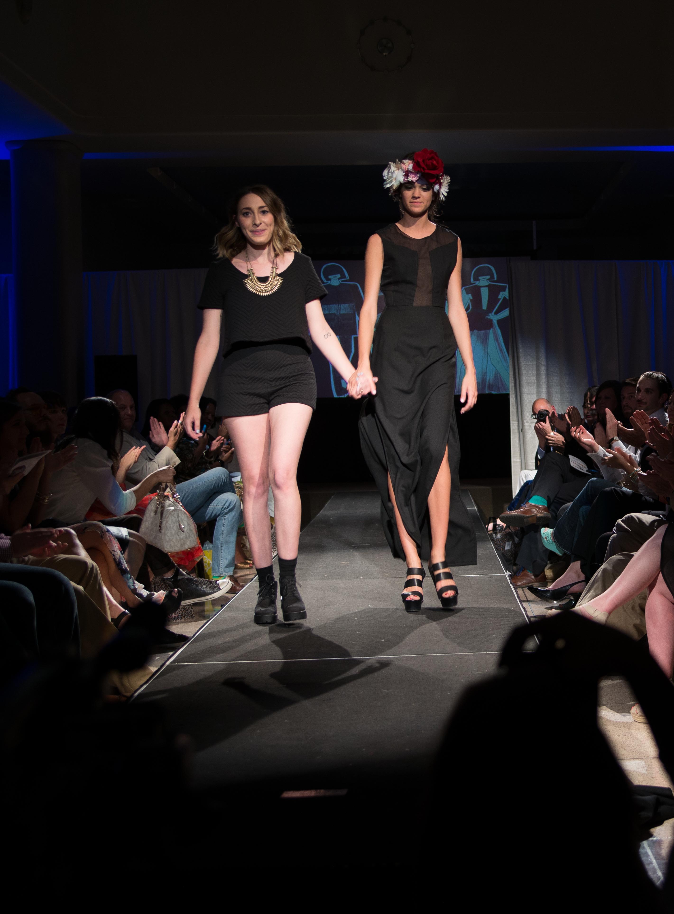 Maddie Louviere, left, walks the catwalk with her model.