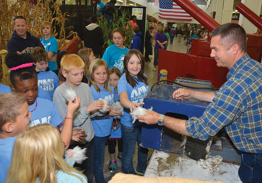 Bentley Fitzpatrick, research associate at the Red River Research Station, shows students cotton aft