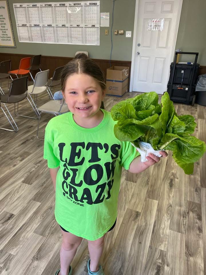 little girl holding lettuce 