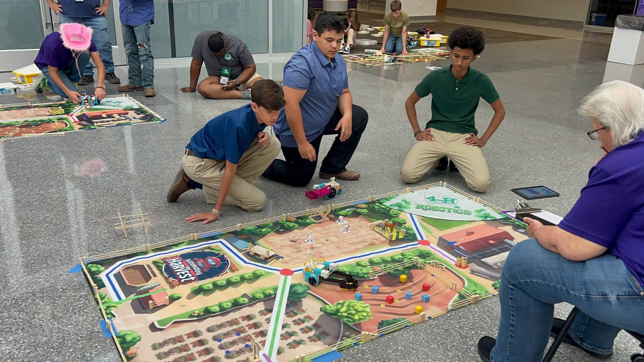 3 boys working with a robot