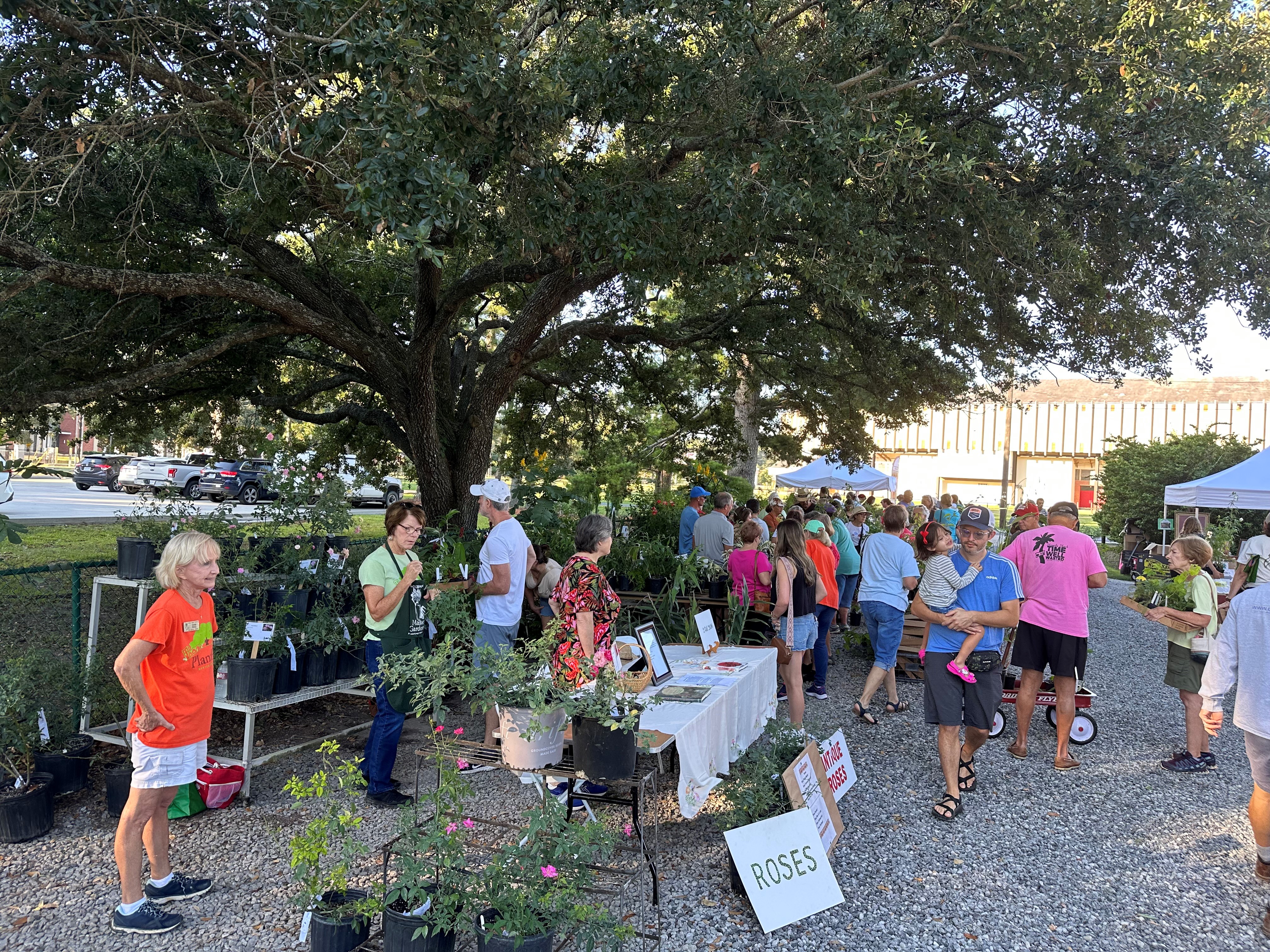 Group of people attending PlantFest. LMG volunteers meeting with attendees to answer plant questions.