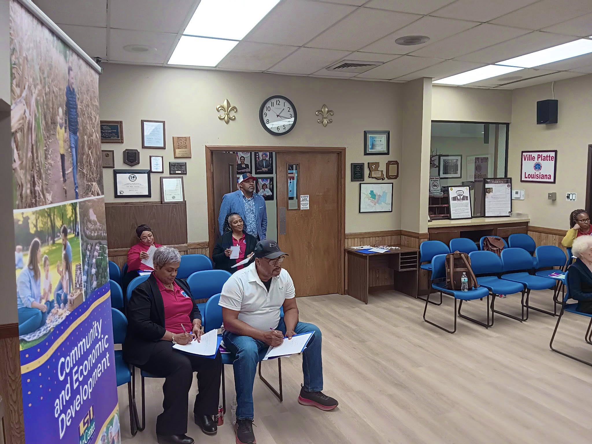 Audience members listening to a presentation.