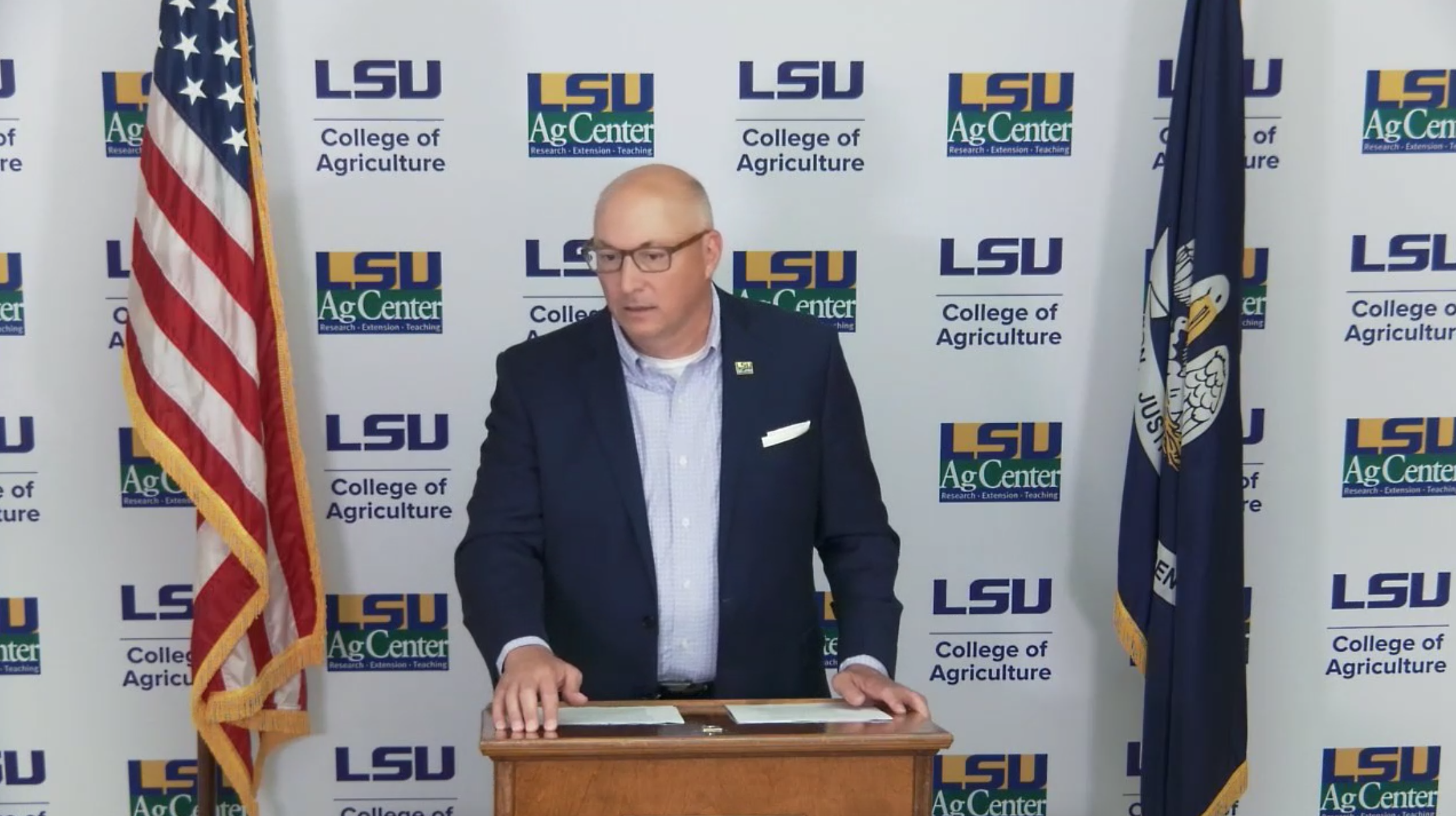 Man speaking at lectern.