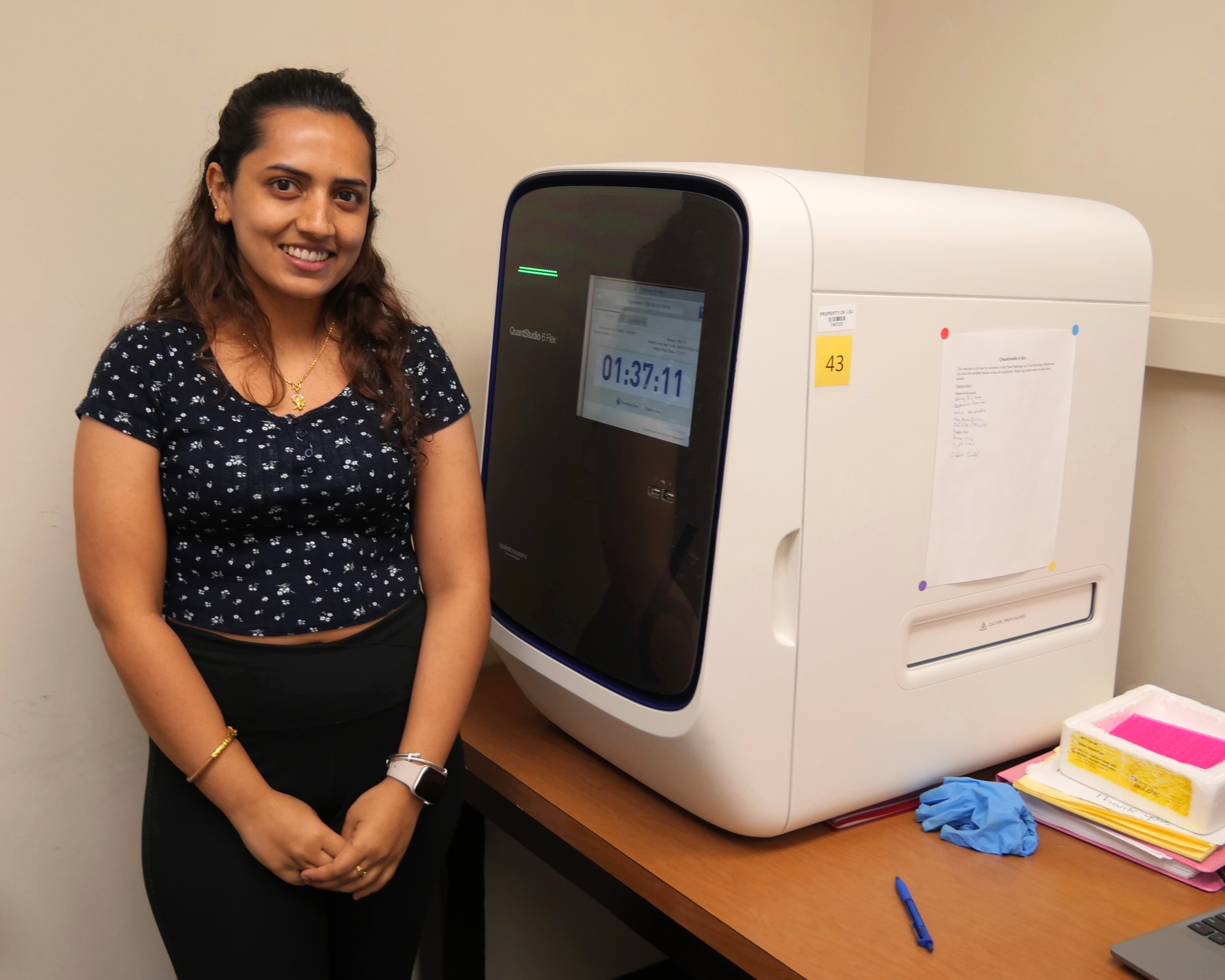 Woman standing in front of a machine.