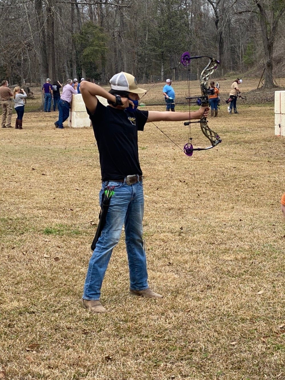 A boy shoots archery.