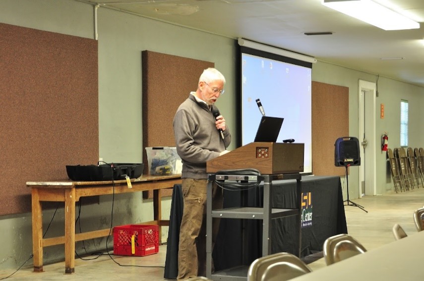 Man speaking behind a podium.