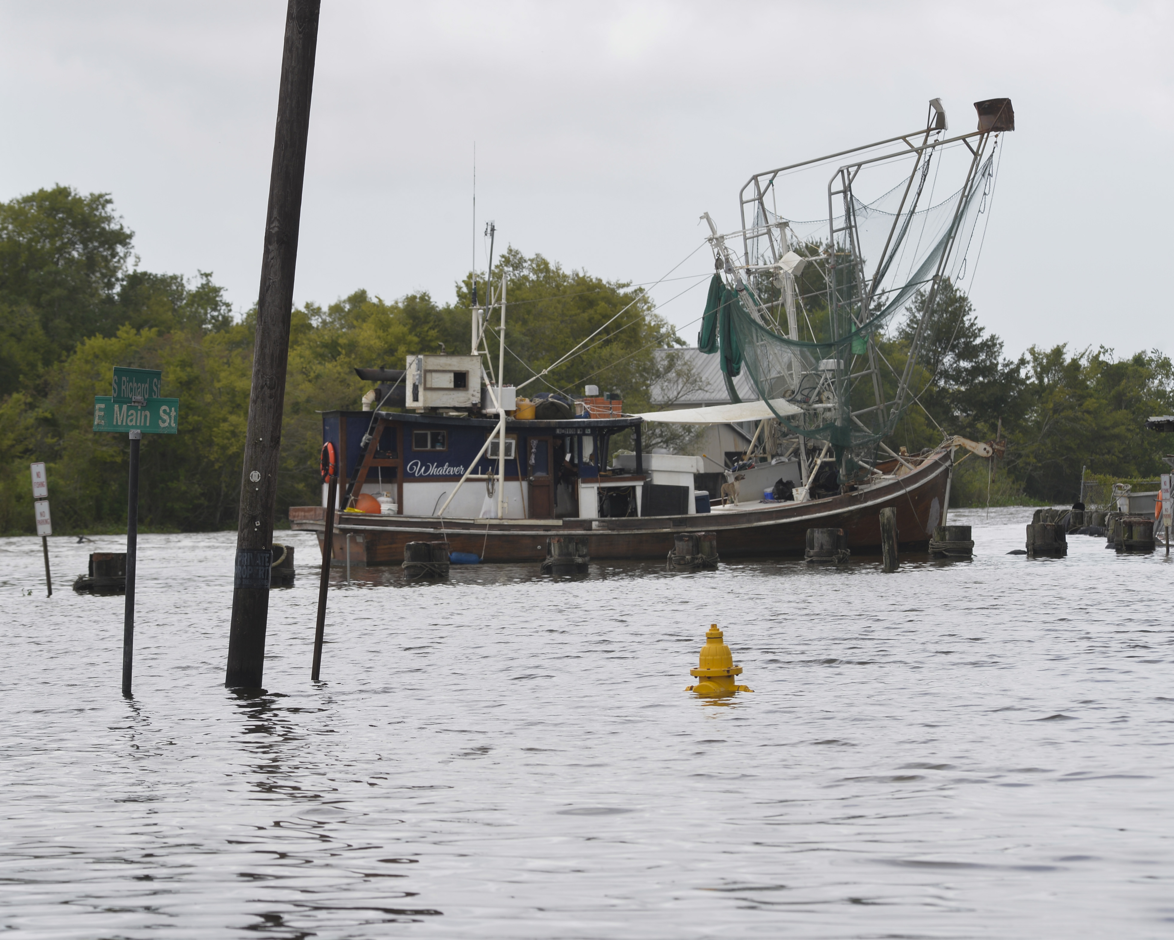 flooded town with a shrimp boat